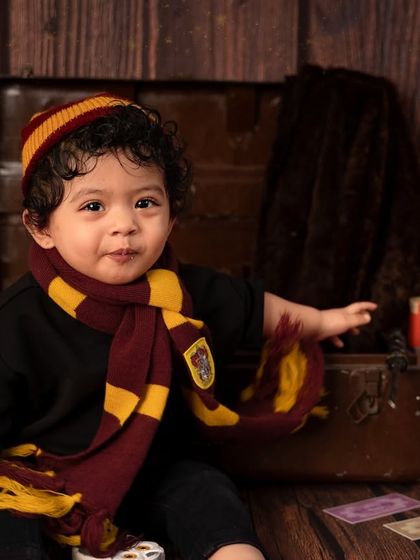 This little wizard is ready to cast a spell of cuteness. The details, like his round glasses and Gryffindor scarf, make this Harry Potter theme so special.