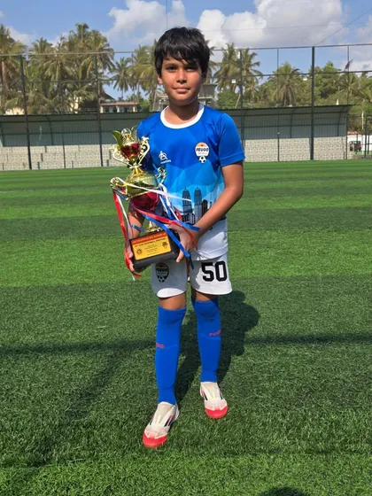 Posing with the trophy, a moment of pride for this U12 player.