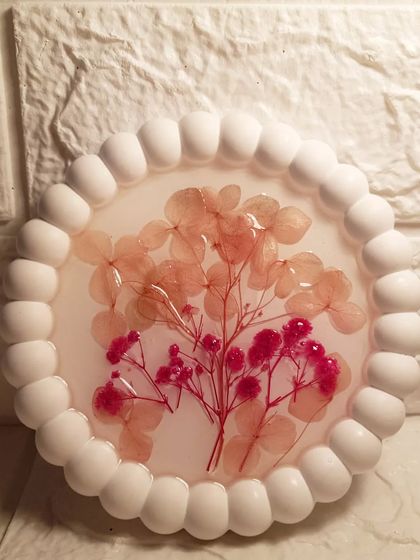 A close-up of the delicate dried flowers captured within the resin. Each flower is placed by hand, creating a unique composition every time.