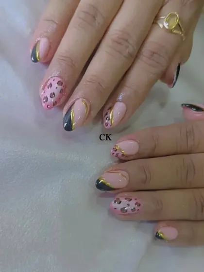 A wild and fun design mixing pink leopard print with black and gold chrome accents.
