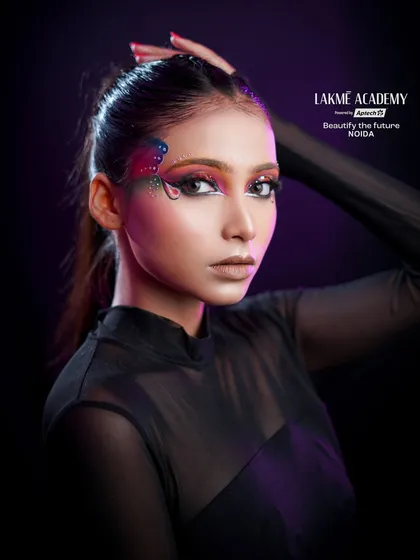 A full portrait of the butterfly-inspired eye makeup. The high ponytail and simple outfit keep the focus on the intricate and beautiful eye art.