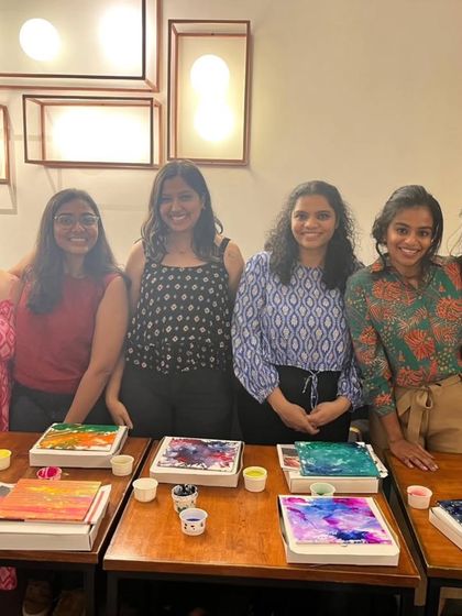 A group of new friends proudly showing off their fluid art creations. It's amazing what you can create in just one afternoon.