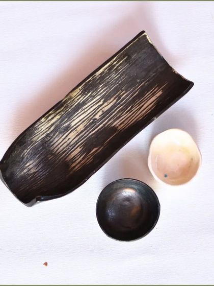 A new creation: a matte black textured platter with a small dip dish. This set is perfect for serving appetizers with style.