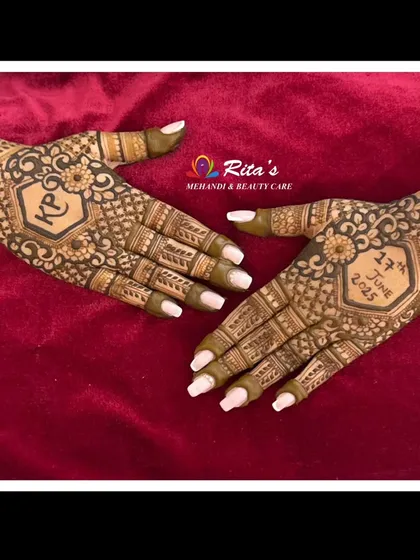 The palms of the Gujarati bridal design, featuring the couple's initials and wedding date.