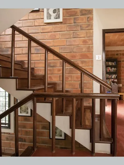 A duplicate of the wooden staircase against the brick wall.