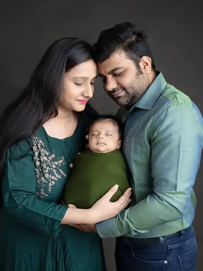 A beautiful first family portrait with a swaddled newborn. I pose families to look connected and serene, creating a timeless memory of this special time.