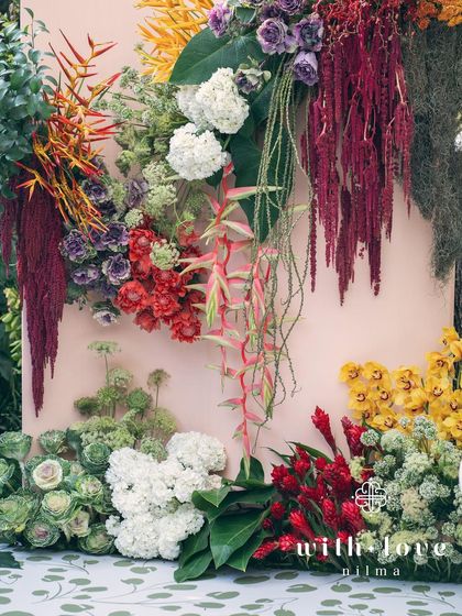 A detail of the 'Garden of Gaia' floral wall, a vibrant and lush backdrop for the celebration.