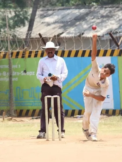 A young bowler, Kunal, in the middle of his delivery stride during a competitive match. A classic action that generates good pace.