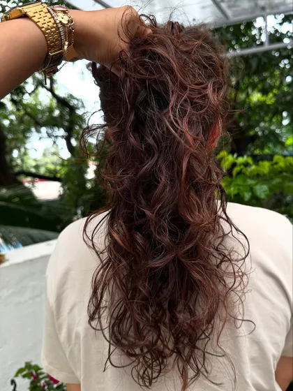 Curly and proud. I gave her curls a new life with a fresh cut, including a fringe, and subtle reddish-brown highlights to define the texture. Embracing your natural curls is always a good idea.