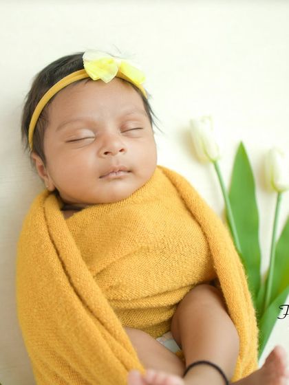 Another angle of the yellow swaddle setup, showing the baby's cute little feet peeking out.