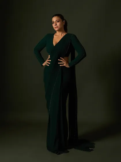 A powerful stance in the custom green saree, showcasing its clean lines and elegant, floor-sweeping drape.