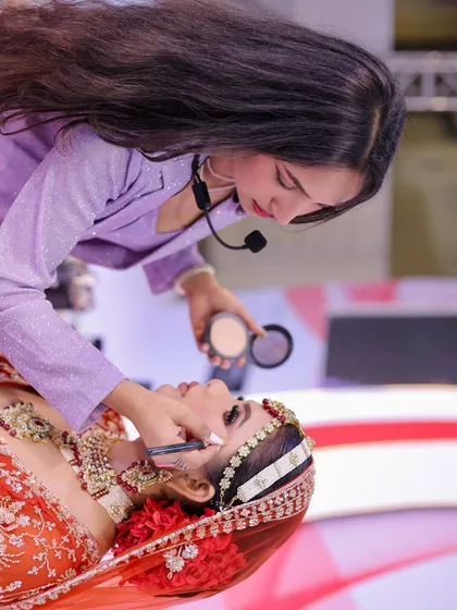 A behind-the-scenes shot from the Beauty Expo. I am demonstrating my eye makeup technique to a live audience.