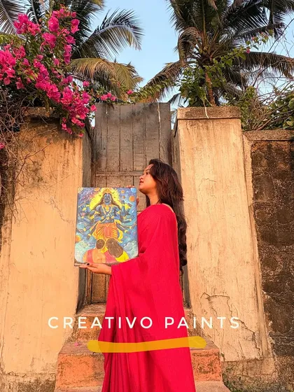 A full-length shot of me holding the Vishnu painting, showcasing its size and vibrant presence.