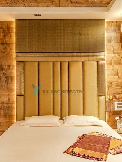 In the master bedroom, we combined a tall, upholstered headboard with rustic wood-paneled walls. This mix of soft and hard textures creates a cozy, cocoon-like feeling, perfect for a restful retreat.