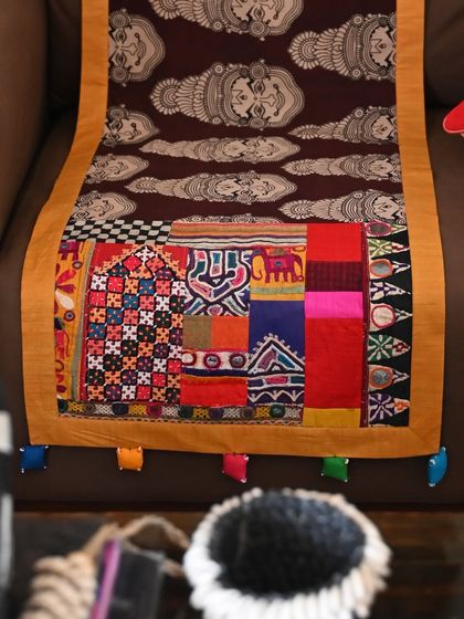 A close-up of the intricate patchwork trim on the Kalamkari runner. These small bits of richly dyed and embroidered fabrics are too precious to throw away and find new life in pieces like this.