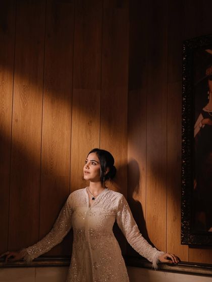 Another angle from a creative photoshoot, using dramatic lighting to create a pensive and elegant mood. This demonstrates my ability to work with photographers to create visually striking images.