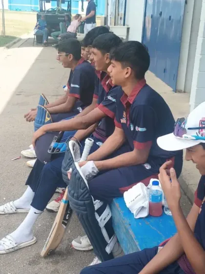 Players watching from the sidelines during a match on their Trinidad tour.