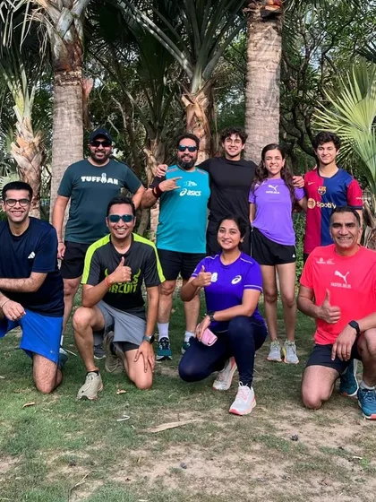 Our running group posing among the palm trees. We love finding beautiful green spots in Delhi for our Sunday runs.