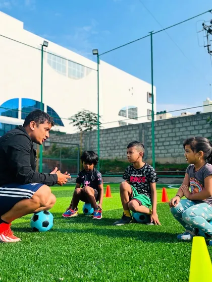 Coaching is more than just drills. It's about connection. Here, I am explaining a concept to some of our youngest players. These moments of mentorship are key to building their confidence and love for the game.