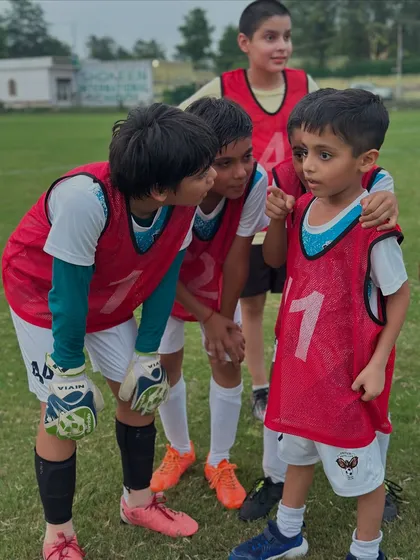 Even our youngest players are strategists. Here, a group of kids plan their approach right before a penalty shootout in a practice game.