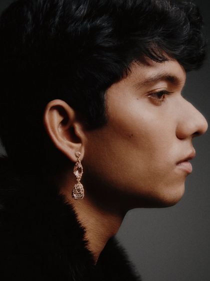 A close-up profile shot from a men's jewelry editorial. The focus is on the delicate earring, showcasing my ability to style accessories for men in a way that feels modern and sophisticated.