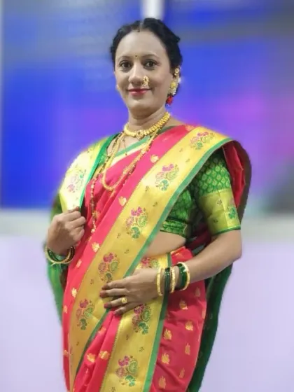 A full-length view of the beautiful Paithani saree. The drape is clean and the pleats are uniform, creating a look of timeless elegance for any special occasion.