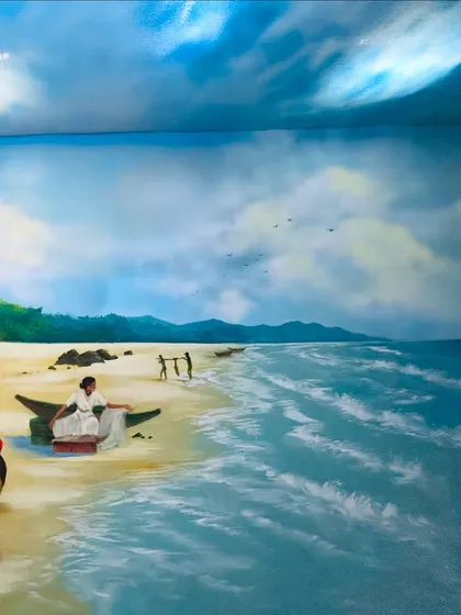 A view of the hand-painted sea and coastline that forms the base of the Navratri decoration. The waves were painted to look like they are flowing towards the Devi's idol.