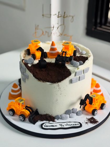 Another creative take on a construction theme, this cake uses edible prints and minimal fondant to create a fun and customized "party zone" for a third birthday.