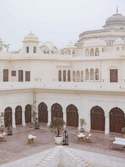 The serene, all-white courtyard of Ranbaas The Palace, Patiala, a stunning backdrop for an engagement ceremony.
