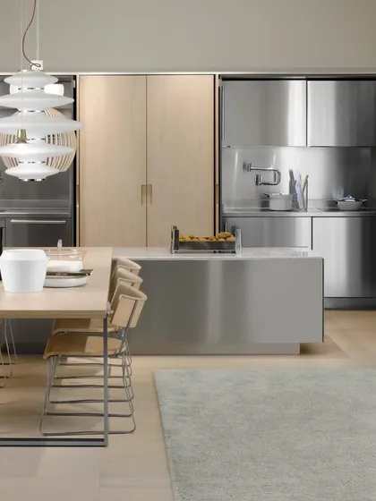 This kitchen showcases the sleek, professional look of stainless steel paired with light wood. It is a perfect example of how I use premium metals to create a durable and modern culinary workspace.