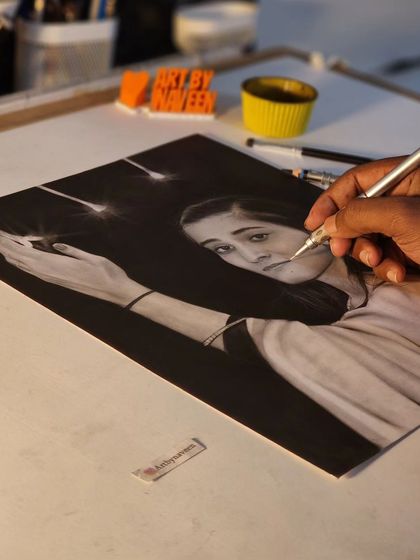 Adding the final sparkling details to the portrait with a fine-tipped eraser.