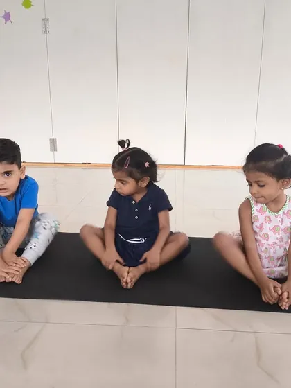 Our indoor gymnastics and fitness classes are perfect for building foundational skills. Here, our little athletes are learning the butterfly stretch, an important part of developing flexibility and body awareness in a calm and focused setting.