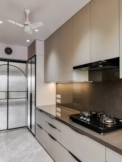 A wide shot of the cooking area, showing the integrated hob and chimney, and the ample counter space.
