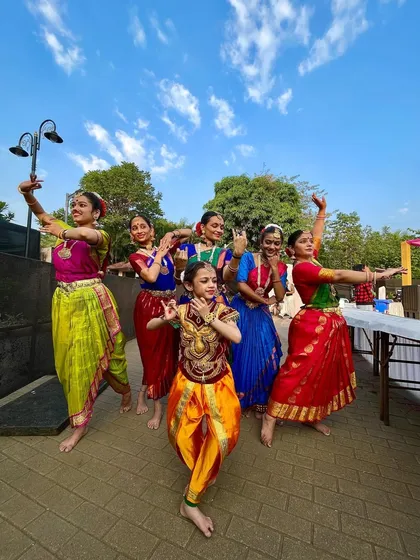 Another joyful group shot, capturing the vibrant energy and colorful costumes of our performers against a beautiful blue sky.