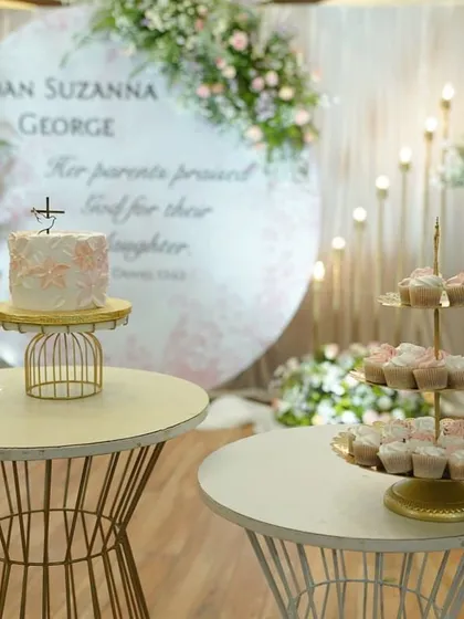 Here’s a full dessert table I created for a baby girl's baptism. It features a delicate floral painted cake and dozens of matching peach and white cupcakes on a tiered stand. I can help you create a beautiful and delicious focal point for your event.