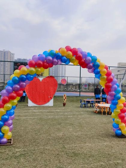 I also handle large outdoor events for schools, communities, or companies. This large, multi-colored balloon arch was set up on a field for a school sports day or fair, creating a festive and cheerful entrance for all the attendees.