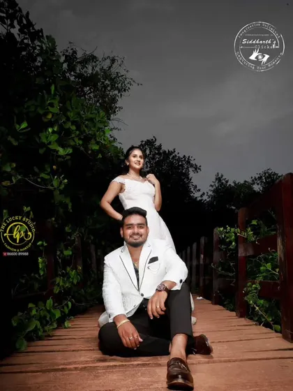 Groom styling is just as important. I ensure the groom looks sharp and camera-ready, like with this modern white blazer and tailored trousers, providing a look that complements his partner perfectly.