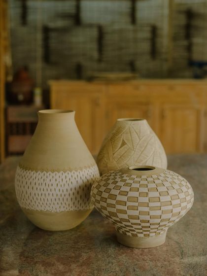 A collection of Prady's finished sgraffito and slip-work pots. His precision with geometric and floral patterns on rounded forms is just incredible.