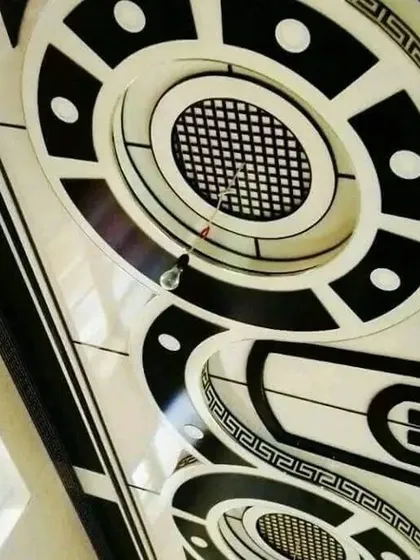 A bold and glossy black and white ceiling design. The intricate geometric and Greek key patterns create a high-contrast, luxurious look that is truly unique.