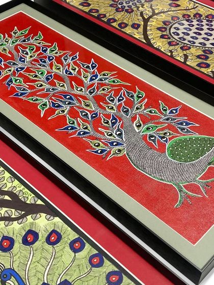 The intricate details of this traditional peacock artwork are perfectly complemented by the layered matting and simple black metal frame.