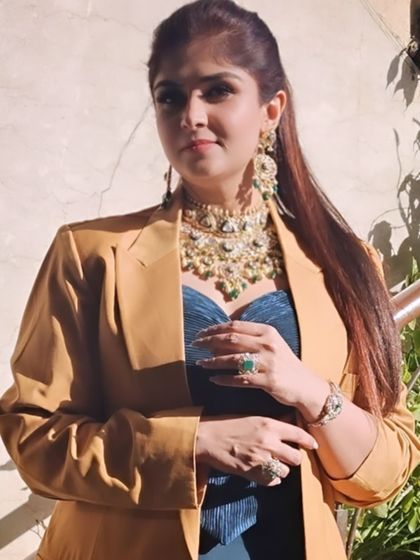 For festive celebrations, I love pairing modern silhouettes with heritage jewelry. Here, a mustard blazer and teal bustier are elevated with a statement Polki and Kundan necklace set.