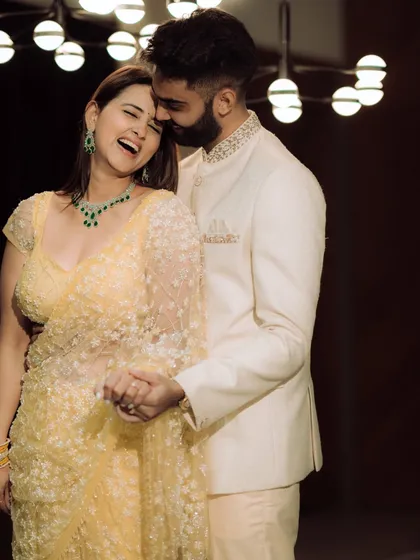 A moment of pure, unscripted laughter. The groom whispers something to his bride-to-be, and her resulting joy is beautifully captured, showcasing the genuine connection that makes for the best photographs.