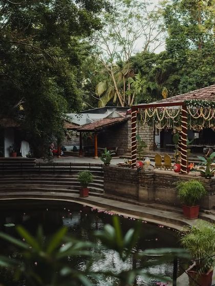 A wide view of the Pond Pavilion and Kalyani, showing the scale of the space and its harmonious integration with nature.