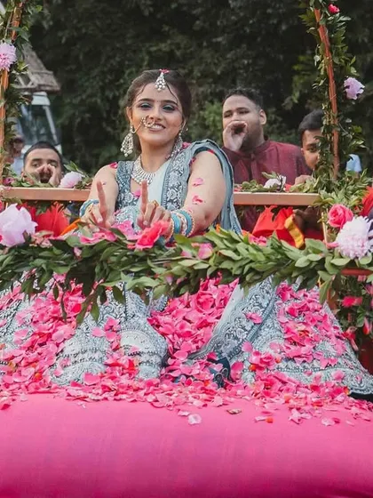 A shower of petals for the beautiful bride during her palanquin entry. We love coordinating these details with the guests to make the bride's entrance even more special and picturesque.