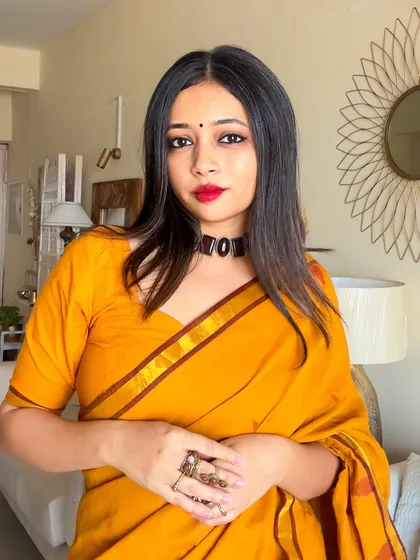 A portrait focusing on the stone choker and the simple bindi, completing the traditional look for Durga Puja.