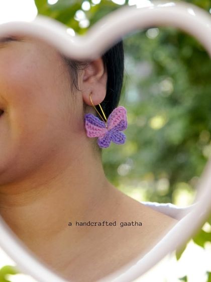 A happy smile from a model wearing the pink and purple butterfly earrings. They are guaranteed to make you feel joyful.