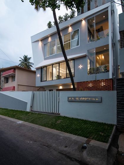The Grey House. This modern home showcases a bold use of angled forms and large glass panels, creating a dynamic and sculptural facade that stands out in its neighborhood.