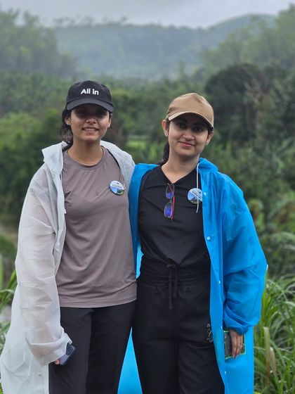 Two friends enjoying the Kurinjal trek, well-prepared for the monsoon weather in their raincoats.