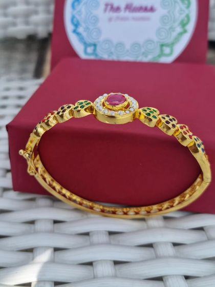 The 'अदा' (Ada) bracelet, showing its adjustable clasp and multi-coloured stone details.