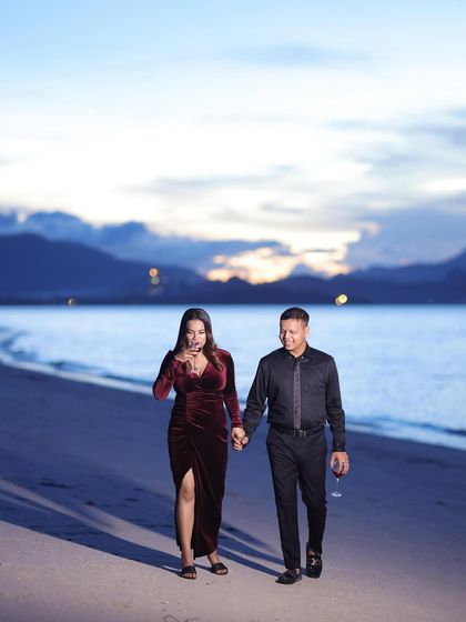 A romantic walk on the beach at sunset. The makeup is soft and glowing, catching the beautiful twilight.